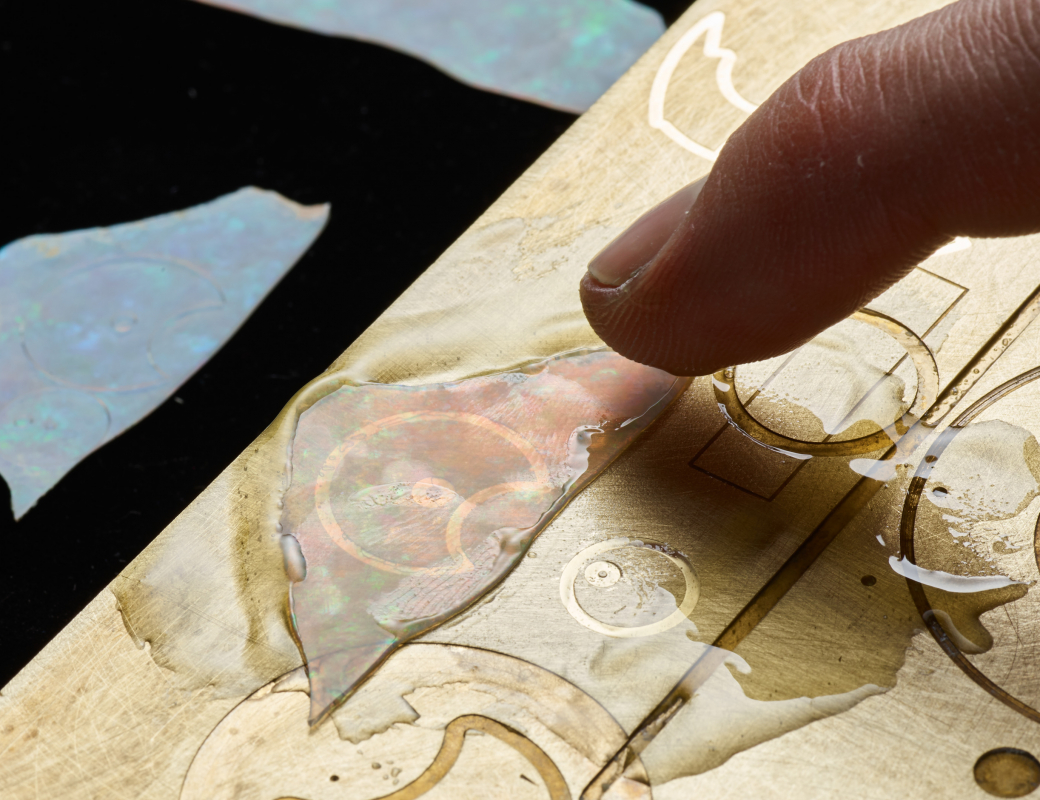 Fixing_an_opal_slice_on_a_heated_base_plate_using_tree_resin_to_make_the_dial_of_the_Romain_Gauthier_Insight_Micro-Rotor_Lady_Opal