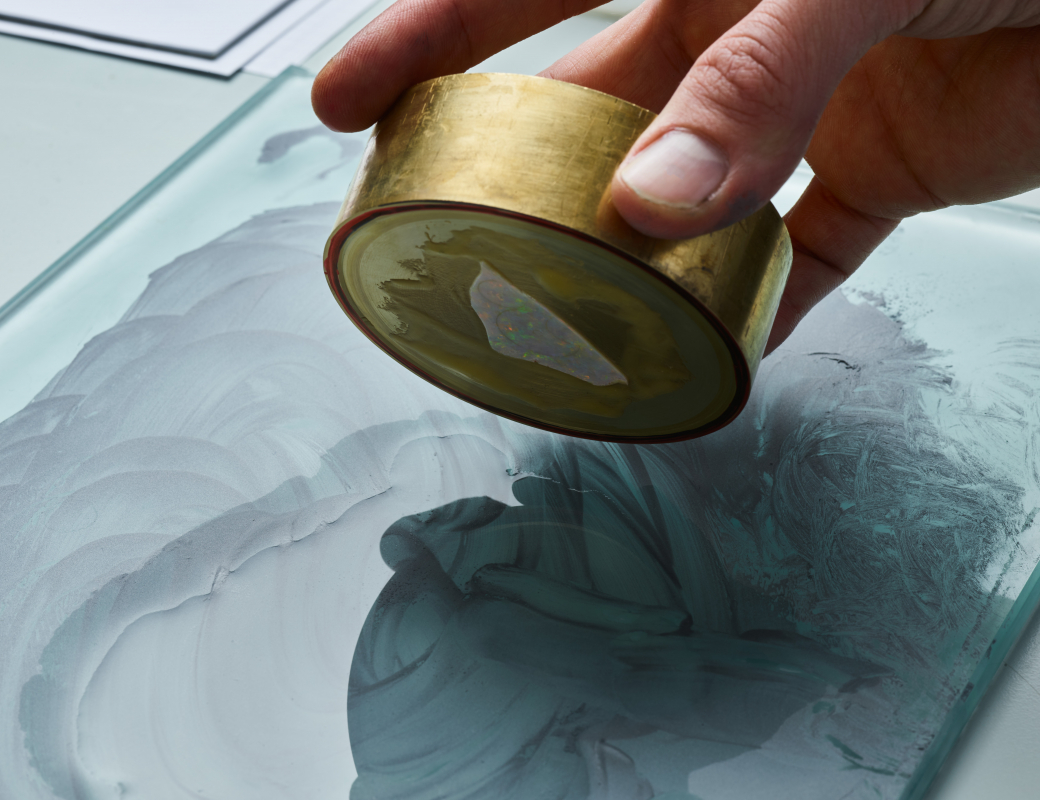 Rubbing_the_opal_by_hand_on_a_glass_board_covered_with_a_mixture_of_diamond_powder_and_water_to make_the_opal_the_right_thickness_for_the_Romain_Gauthier_Insight_Micro-Rotor_Lady_Opal
