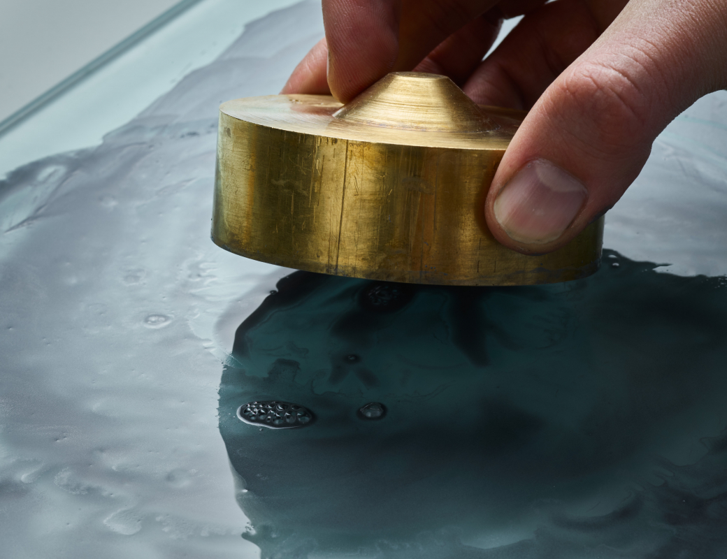 Rubbing_the_opal_by_hand_on_a_glass_board_covered_with_a_mixture_of_diamond_powder_and_water_to make_the_opal_the_right_thickness_for_the_Romain_Gauthier_Insight_Micro-Rotor_Lady_Opal